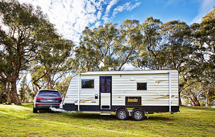 Towing car and an Innovation caravan in the forest