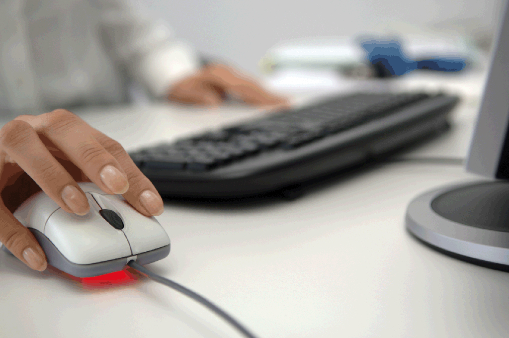 A close up of a woman using mouse while surfing the Internet