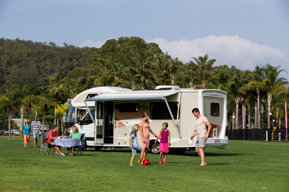 happy couple showing map on their caravan trip
